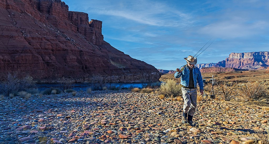 A fly fishing guide calling it a day walking away from river